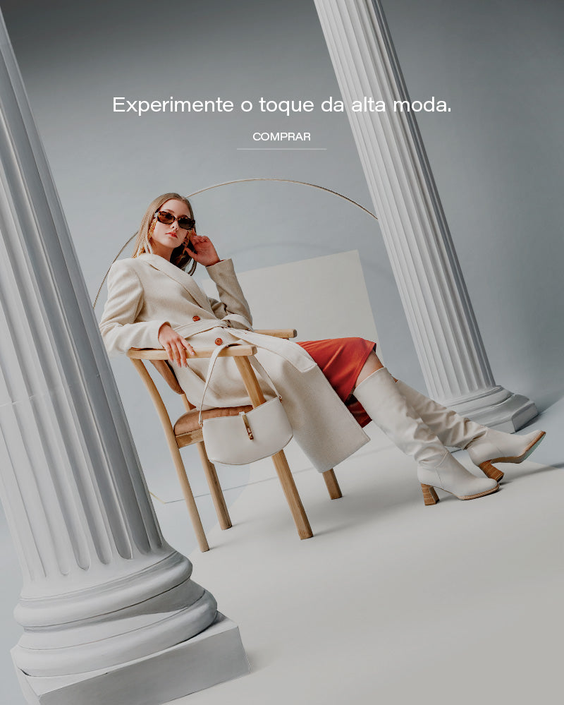 Banner editorial AVONNUE com modelo feminina em sobretudo claro estruturado, bolsa sofisticada e cenário arquitetônico minimalista.