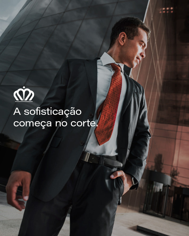 Banner editorial AVONNUE com homem em terno estruturado e gravata vermelha sofisticada, em cenário urbano corporativo elegante.