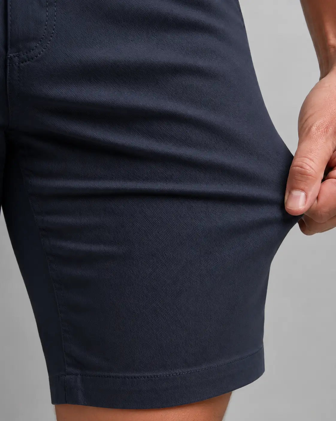 Bermuda Masculina em Sarja Valori Azul Marinho, vista de frente em detalhe no corpo em fundo branco.