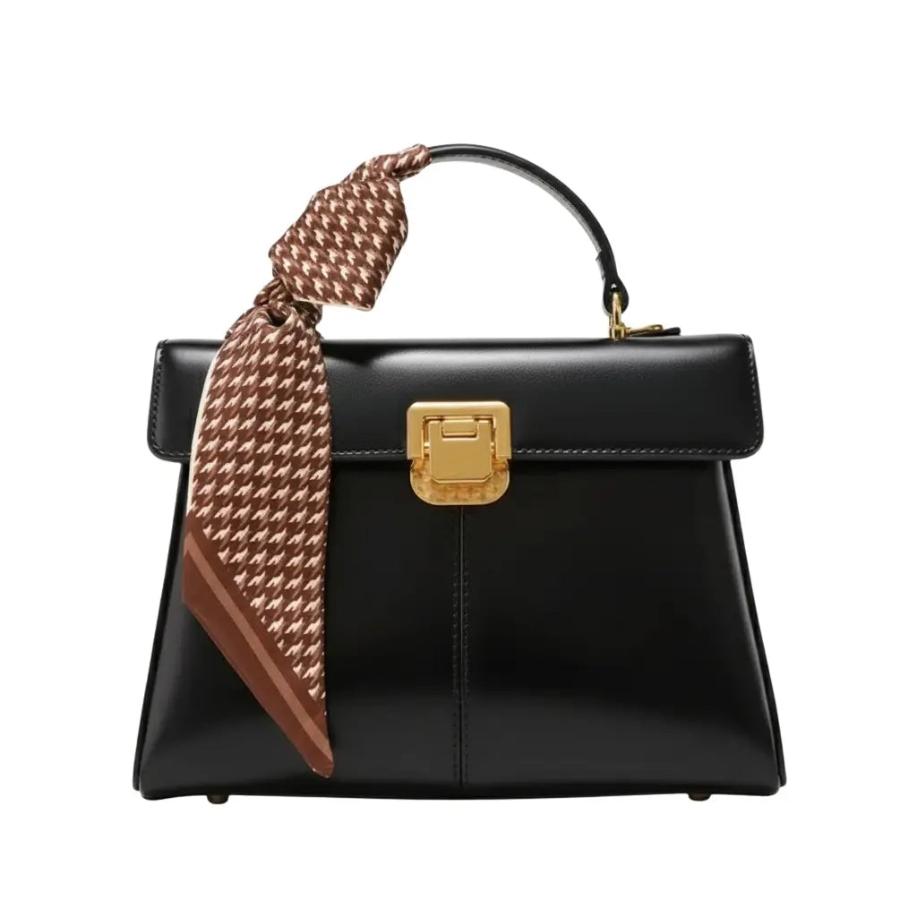 Bolsa feminina preta estruturada AVONNUE com fecho dourado e detalhe de lenço marrom elegante na alça.